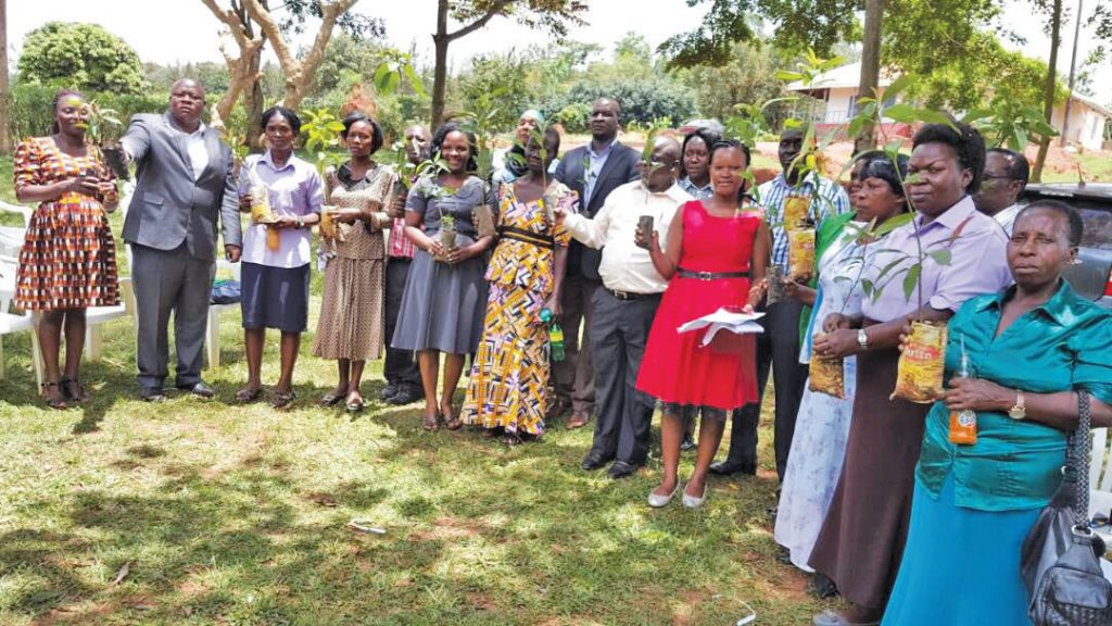 Giving out tree seedlings to Kyengera Town Coucil community